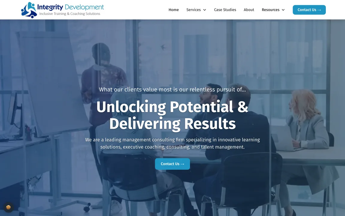 Integrity Development homepage with the headline Unlocking Potential & Delivering Results over a blue-tinted photo of a team meeting, and a Contact Us button.