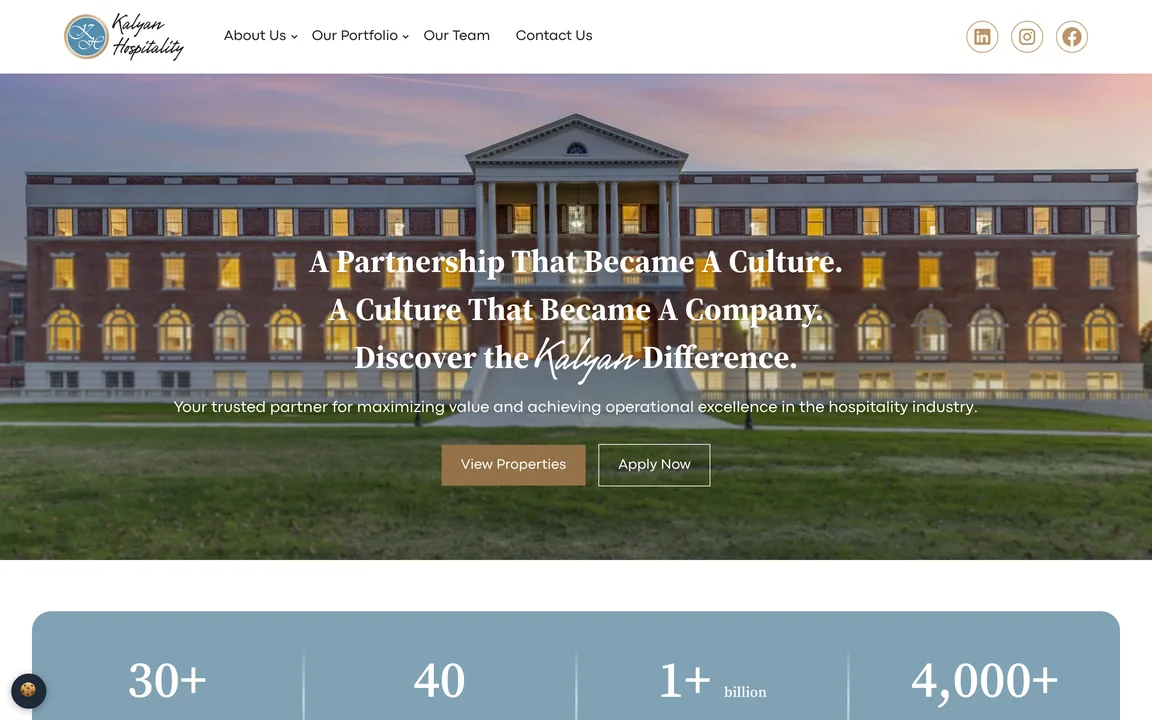 Homepage hero over a photo of a columned brick hotel at dusk, reading A Partnership That Became A Culture, with View Properties and Apply Now buttons.