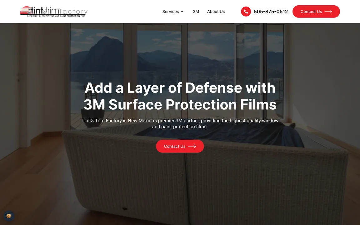 The Tint & Trim Factory homepage with the headline Add a Layer of Defense with 3M Surface Protection Films over a photo of a room with large windows, a red Contact Us button, and the phone number in the header.
