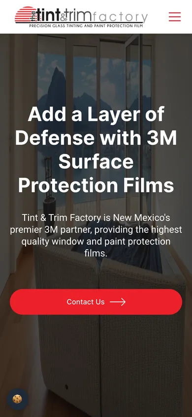 Mobile view of The Tint & Trim Factory homepage with the logo, menu button, headline and a full-width Contact Us button.